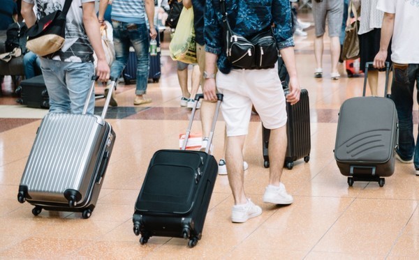 travelers with caarrybags in airport.jpg